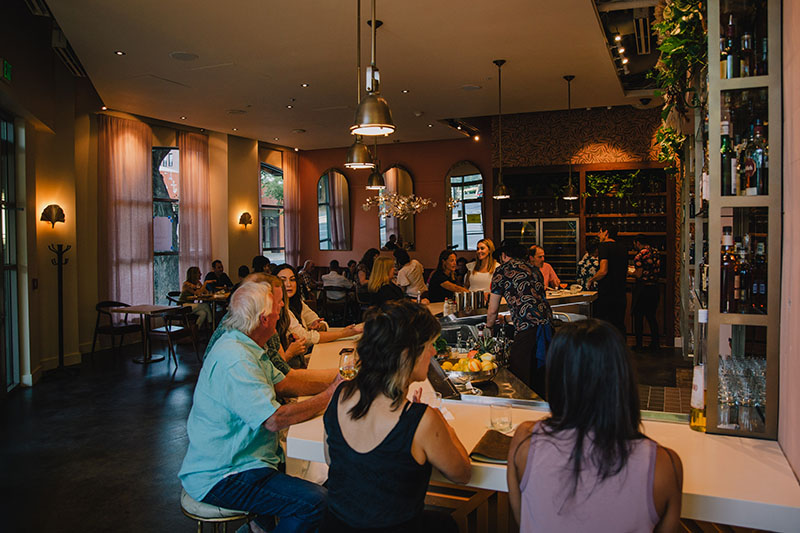 A group of people sitting at the bar